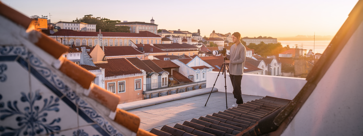 [Photographer capturing sunrise landscape during a travel photography trip with a mirrorless camera]